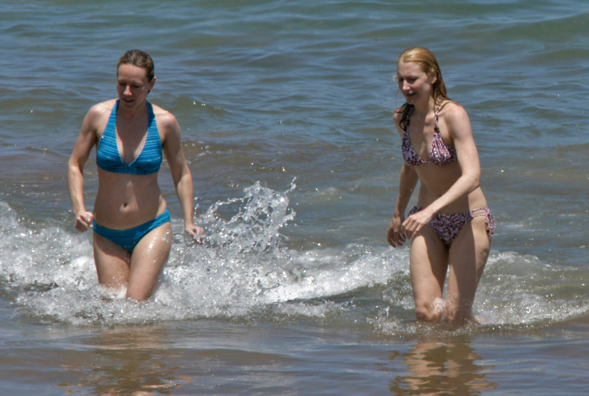 Amy Ryan and Patricia Clarkson frolic on the beach in bikinis.
