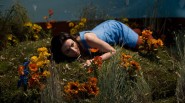 Caterina Scorsone as Alice Hamilton laying in the grass