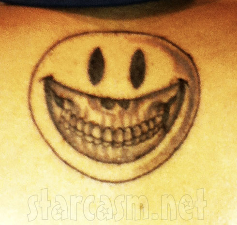 Chris Brown's new tattoo of a smiley face with a skull underneath on his 