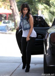 Kim Kardashian pumps some gas while showing off her most famous assett