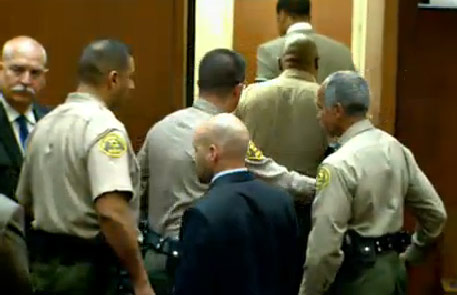 Dr. Conrad Murray escorted away in handcuffs