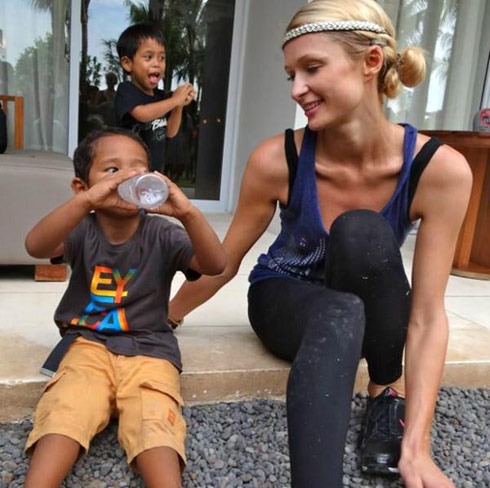 Paris Hilton sits with an orphan in Bali