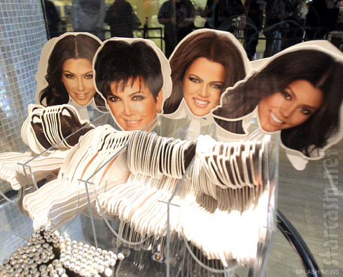 Fans with photos of the Kardashian's faces on them at Kardashian Khaos