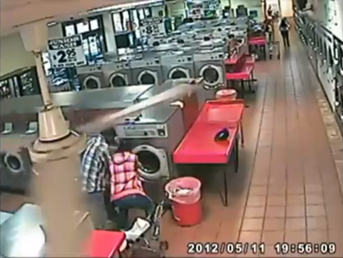 Laundromat security camera catches dad putting his child inside a washing machine