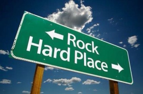Between a rock and a hard place street sign